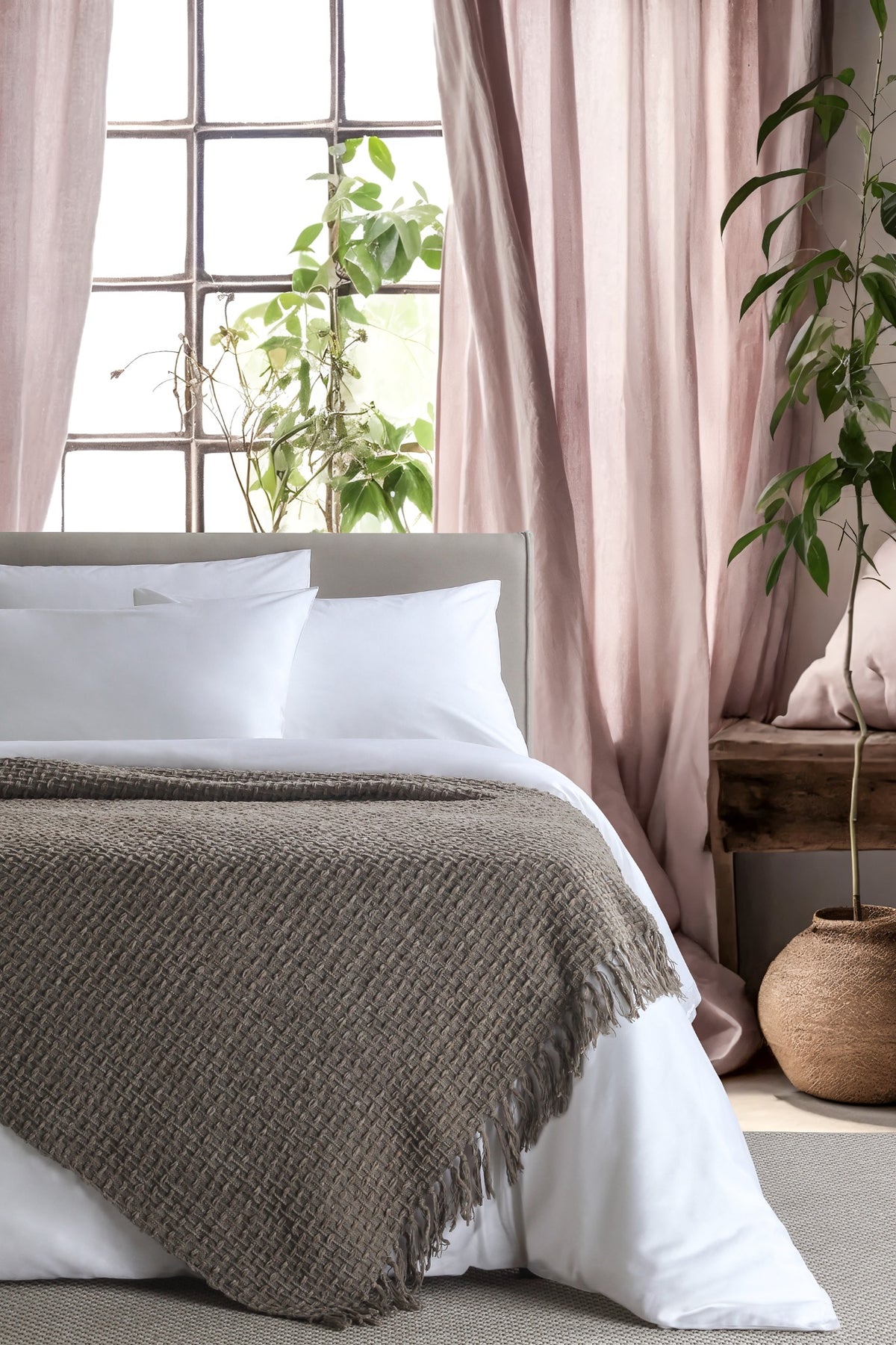 Devina Grey throw — styled on a bed