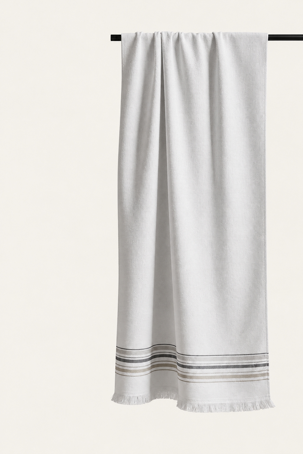 One Hannes pestemal in Grey, with its original woven striped border and fine fringe, photographed in soft neutral light