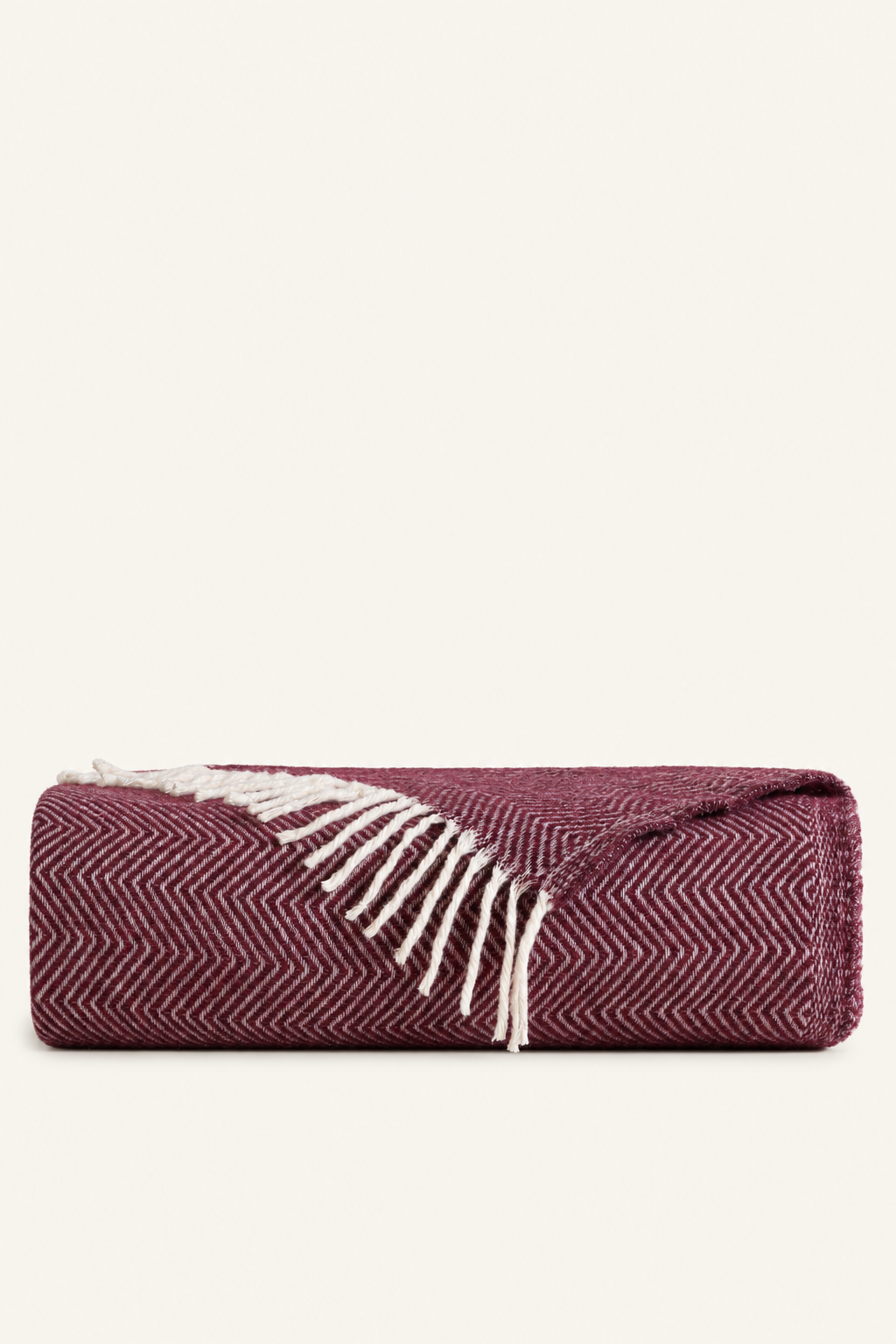 Nevada Plum blanket folded on a light beige background
