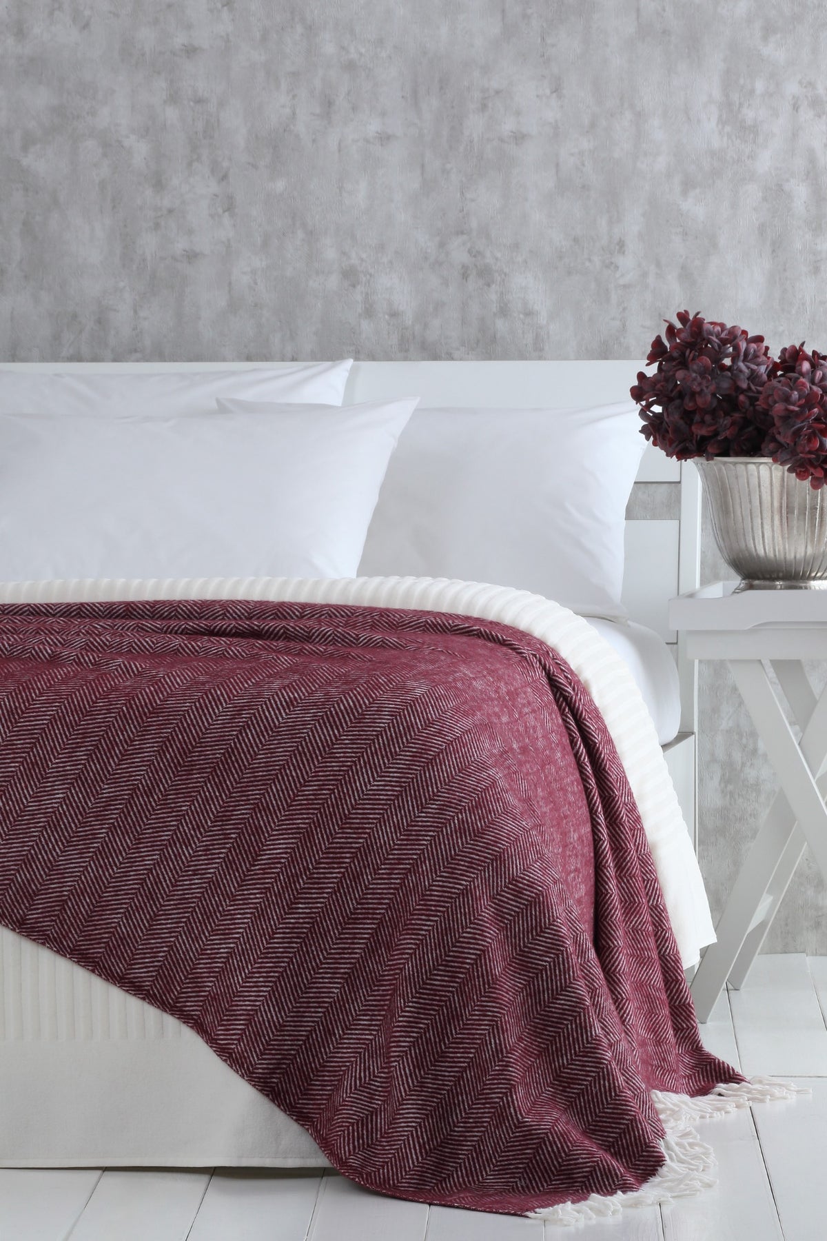 Nevada Plum blanket styled on a bed