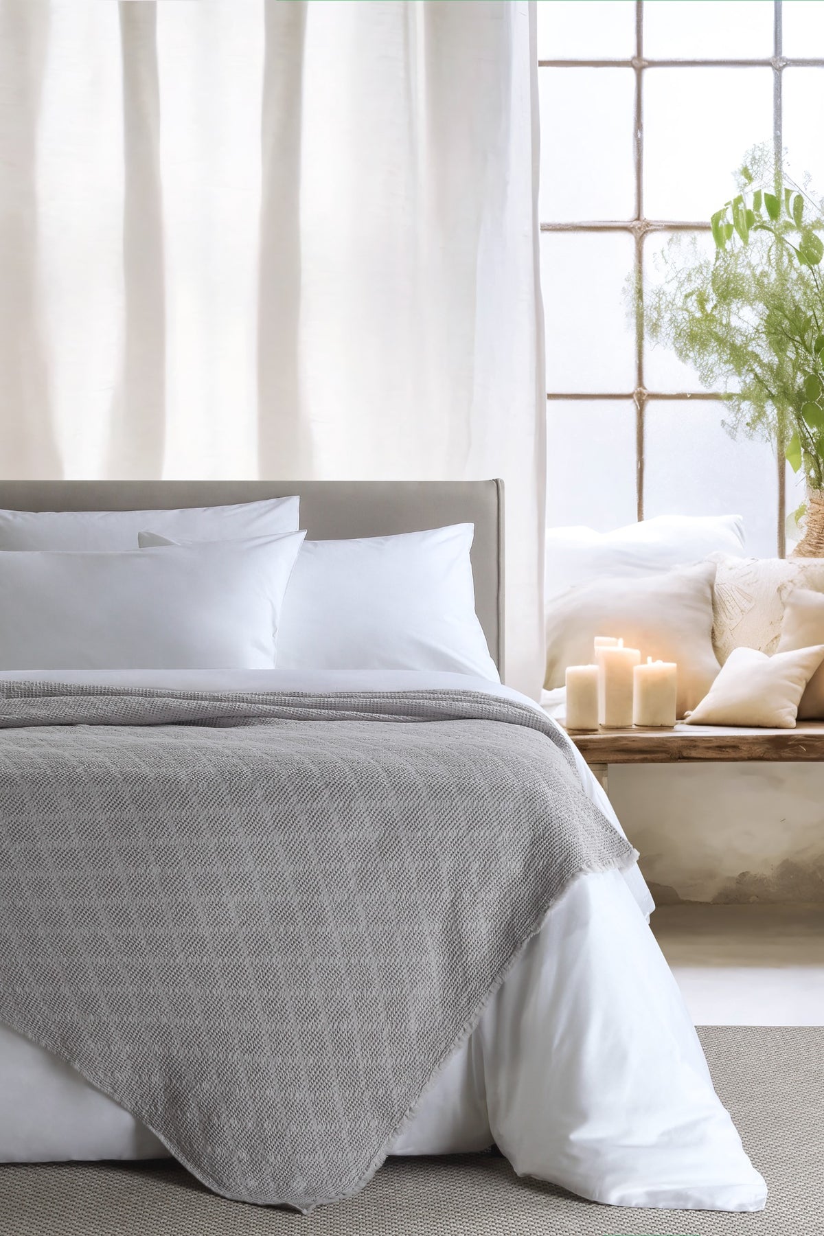 Noyce Grey throw — styled on a bed
