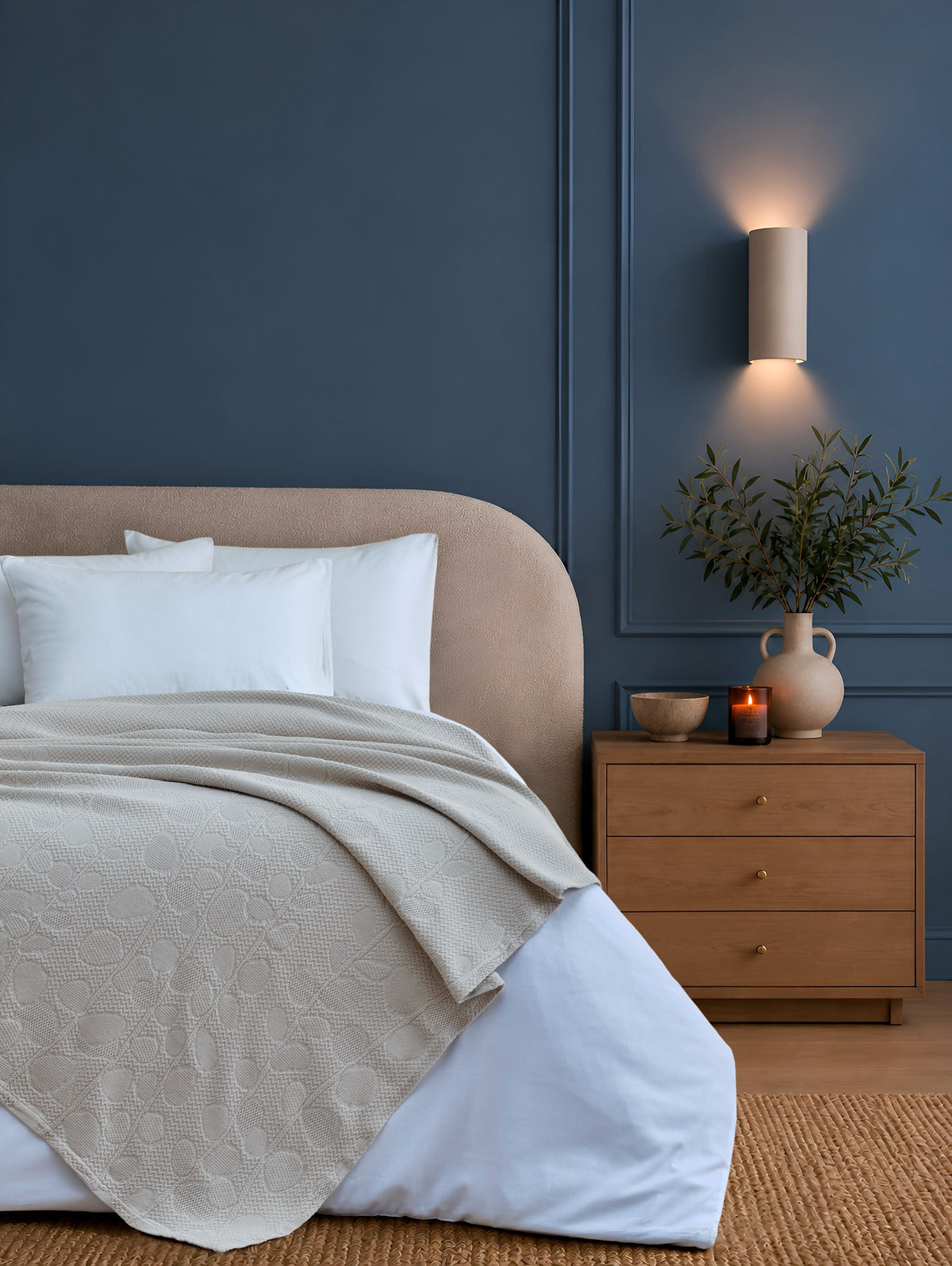 Solena beige throw with leaf motifs styled on a bed