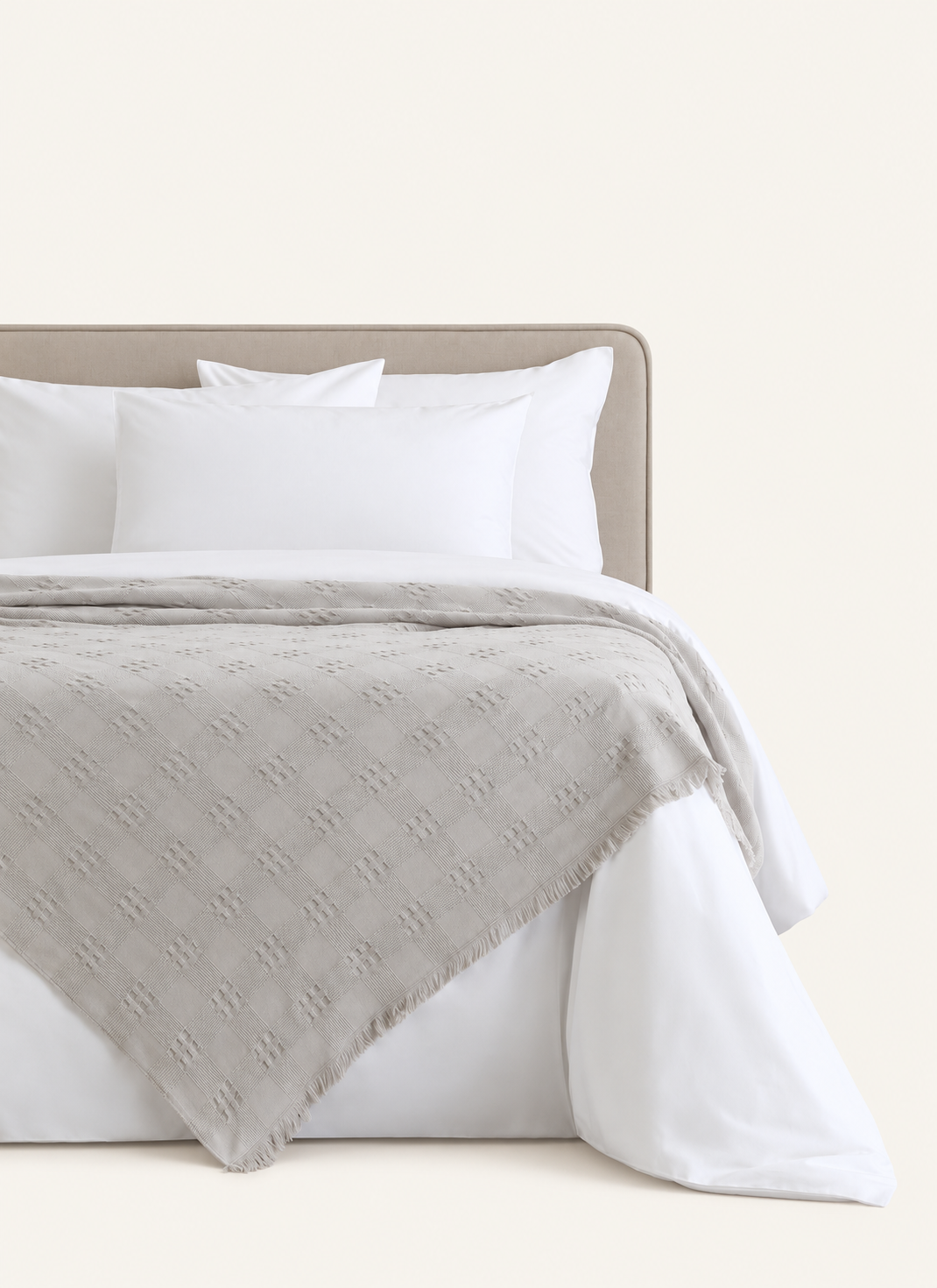 Danna Grey bedspread displayed on a bed against a light beige background
