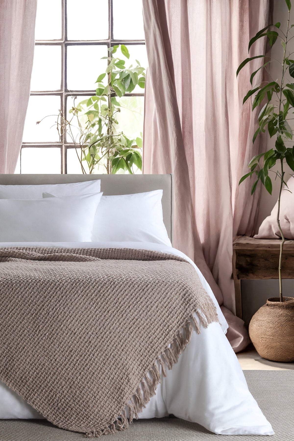 Devina Beige throw — styled on a bed