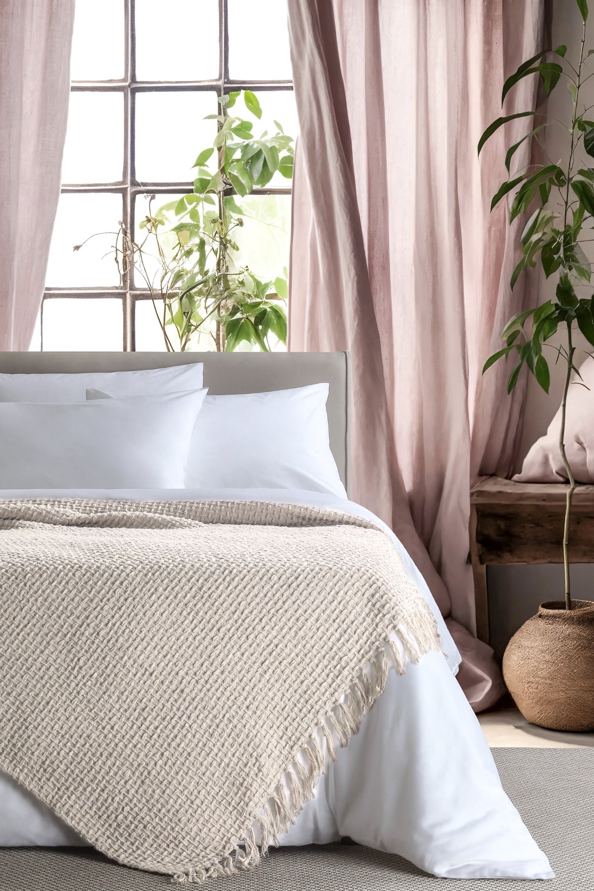 Devina Ecru throw — styled on a bed