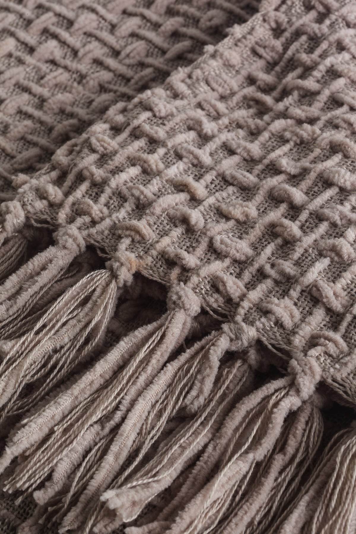 Devina Beige throw — woven texture and tassel detail