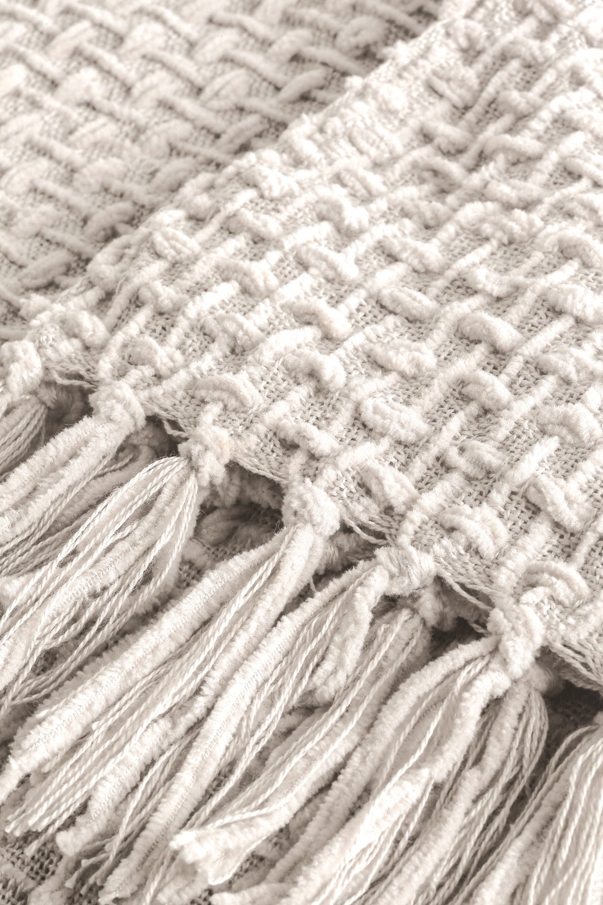 Devina Ecru throw — woven texture and tassel detail