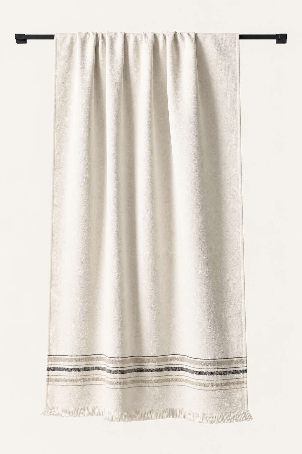 One Hannes pestemal in Beige, with its original woven striped border and fine fringe, photographed in soft neutral light