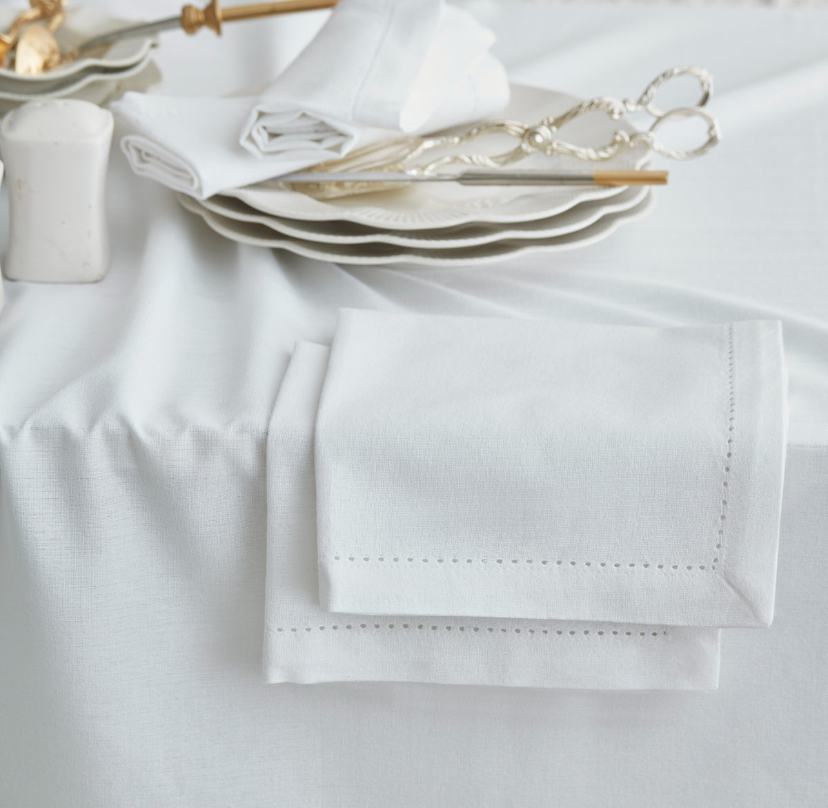 Detail of Jolly White tablecloth with matching napkins styled on the table