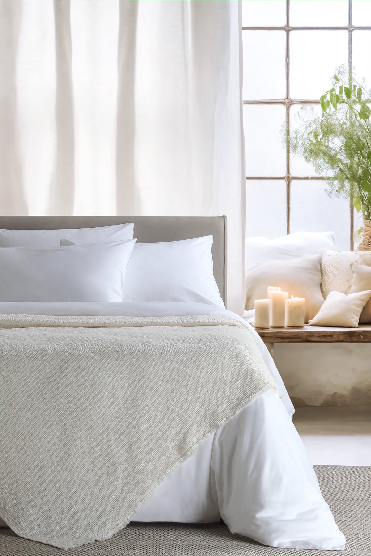 Noyce Ecru throw — styled on a bed