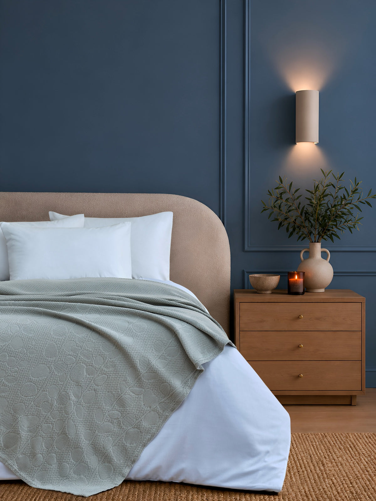 Solena khaki throw with leaf motifs styled on a bed