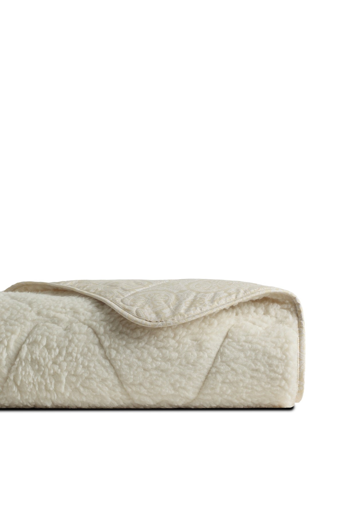 Verona blanket folded, showing its textured surface and patterned reverse